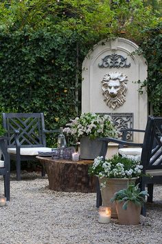 an outdoor seating area with candles and flowers