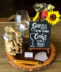 wine corks are arranged on a wood slice with a sign that says guess how many cups win a prize