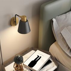 a nightstand with a lamp and books on it