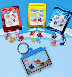 an assortment of sea animals and magnets on a blue background with a keychain