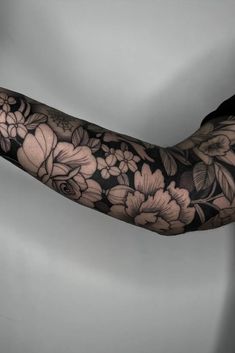 the arm is covered with black and white flowers, while it's in full bloom