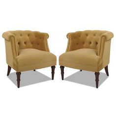 a pair of beige chairs sitting next to each other