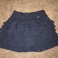 Navy Blue Hollister Skirt! Never Worn, Size Small Blue Ruffled Skort For Beach, Blue Ruffled Mini Skirt For Beach, Navy Casual Pleated Skirt Skort, Casual Navy Pleated Skort, Navy Casual Pleated Skort, Blue Tiered Skirt For Day Out, Casual Blue Ruffled Bottoms, Blue Mini Skirt With Ruffles, Blue Ruffled Skort