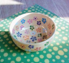 a polka dot table cloth with a bowl on it