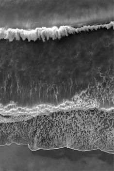 an aerial view of the ocean with waves