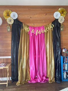 there is a black and gold drape with no barriers on it in front of a wood paneled wall