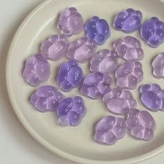 there are many purple candies on the plate