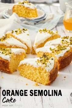 slices of cake with white frosting and pistachio sprinkles on top