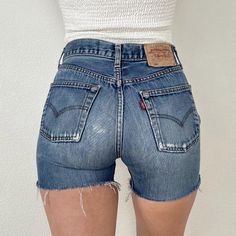 Vintage 501 Medium Wash Distressed Levi's Cutoff Shorts//27" waist, 10.75" rise, 4" inseam, 34.5" upper hip, 39.5" hips, 22" thigh! Would fit a size 26 best imo, or maybe a 26/27 if you want them on the snugger side, but check your measurements and ask me questions. Great quality 100% cotton denim and these actually hug your booty! They have awesome wear and fading with light distressing and a patched seat that adds great character! Price firm We ship internationally! SVS00477 Vintage 501, Cutoff Shorts, Cut Off Shorts, Cut Off, Short Outfits, Womens Bottoms, Levi's, Bathing Beauties, Womens Shorts