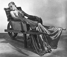 a black and white photo of a woman sitting in a chair