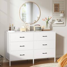 a white dresser and mirror in a room