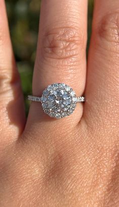 a woman's hand with a diamond ring on it