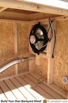 the inside of a shed with a blower attached to it