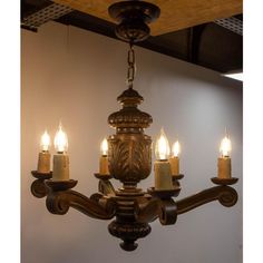 a chandelier with five lit candles hanging from it