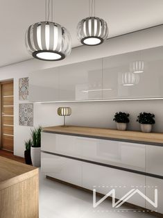 an image of a modern kitchen setting with lights on the ceiling and potted plants