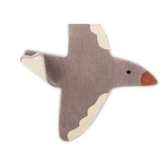 an animal shaped rug with a bird on it's head and tail, in grey tones