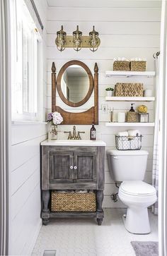 the bathroom is decorated in white and has an old fashioned vanity with mirror above it