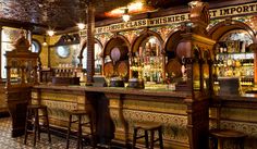 an old fashioned bar with lots of stools