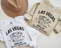 three t - shirts that say las vegas, drink and dice are sitting next to each other