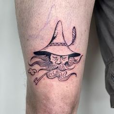 a man's leg with a wizard hat on top of his head and a pipe coming out of it