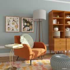 an orange chair sitting in front of a wooden bookcase next to a table with a lamp on it