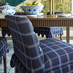 a blue and white chair sitting in front of a table with fruit on top of it