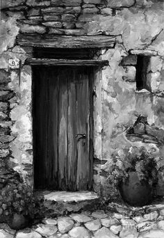 a black and white photo of an old stone building with a door in the middle