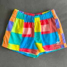 the colorful shorts are laying on the floor