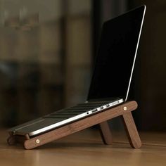 a laptop is sitting on a wooden stand