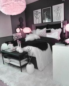 a bedroom decorated in black and white with pink accents on the walls, bedding and decor