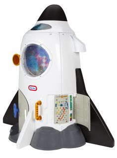 a white and black toy rocket ship sitting on top of a table