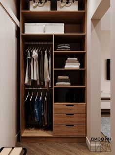 an open closet with clothes hanging on the shelves and drawers, along with other items