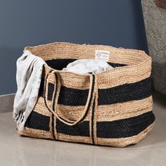 a large black and white striped basket sitting on top of a table