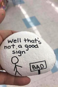 a hand holding a rock with the words well that's not a good sign on it