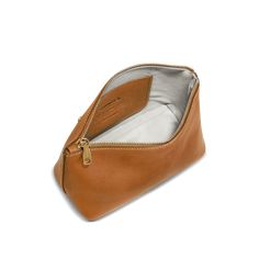 a tan leather purse with zippers on the inside