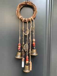 a wreath with bells hanging from it's side next to a wall mounted door