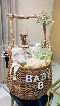 a wicker basket filled with baby items on top of a table next to a window