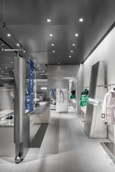 the inside of a clothing store with clothes on display