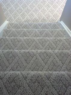 carpeted stairs leading up to an open door