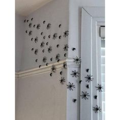 the wall is decorated with black spider decorations