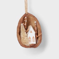 a wooden ornament with a house in the middle and a tree inside it