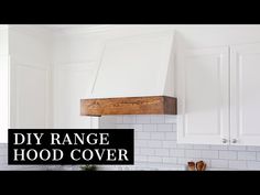 a kitchen with white cabinets and black lettering that says diy range hood cover