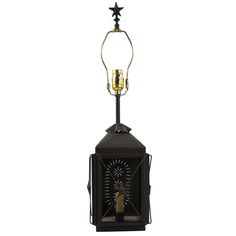 a black and gold lantern with two stars on it's top, sitting next to a candle holder