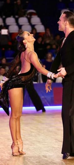 a man and woman are dancing on the ice