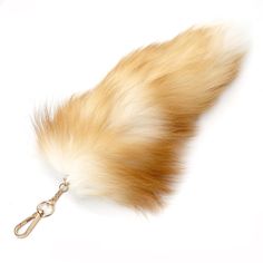 a furry animal tail is attached to a keychain