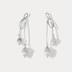 Elevate your elegance with our Silver Lily Of The Valley Bow Earrings. Crafted in sterling silver, these delicate earrings showcase the iconic Lily of the Valley motif in a charming bow design. A touch of femininity and nature-inspired grace, these earrings are perfect for adding a subtle yet timeless accent to your look.  🎀 DETAILS Materials:  Sterling  Silver, Pearl Size: 2.09"* 0.31 "(5.3cm*0.8cm) Weight: 7.4g/pr Feminine Silver Earrings For Anniversary, Silver Feminine Flower Earrings, Silver Dangle Earrings, Feminine Style, Silver Dangle Earrings Feminine Style, Silver Feminine Flower Earrings For Formal Occasions, Feminine Silver Dangle Earrings, Feminine Silver Flower Earrings, Feminine Silver Flower Drop Earrings, Feminine Silver Dangle Flower Earrings