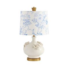 a white lamp with blue and white flowers on it