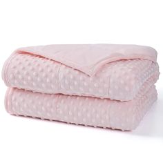 two pink blankets stacked on top of each other in front of a white background,