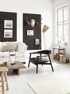 a living room with white furniture and blue walls