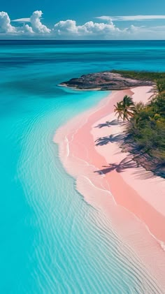 an island with pink sand and palm trees in the water, surrounded by blue waters